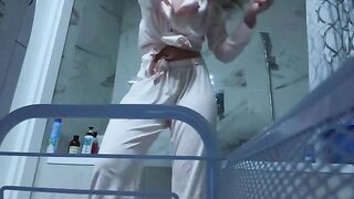 A petite girl caresses her sweet pussy in the bathroom, no one sees it