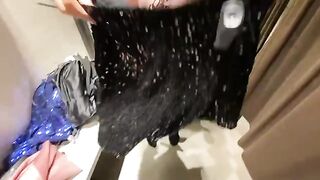 The girl chooses a dress in the fitting room and gets fucked