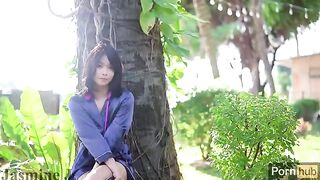 A cute Asian girl wets her pussy in the sunny garden