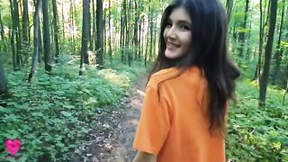 A girl is checking her figure in the forest when a guy comes