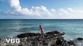A petite girl is fucking on the beach without any clothes