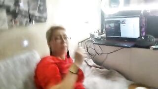 A mature woman is playing with her pussy on camera and gets fucked
