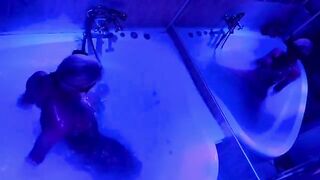 A blonde is having fun with a sex toy in the bathroom