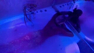A blonde is having fun with a sex toy in the bathroom