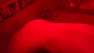 A blonde is having fun with a sex toy in the bathroom