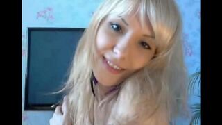A cute blonde caresses her pussy with her fingers