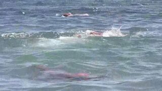 A mature woman sunbathes nude on the beach in this hot video