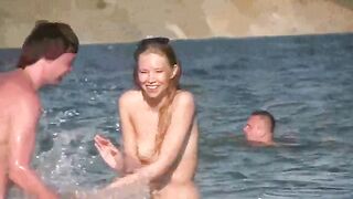 A mature woman sunbathes nude on the beach in this hot video