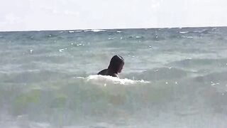 A group of girls sunbathes naked on the beautiful beach