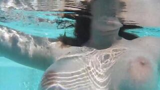A hot chick masturbating a dildo right in the swimming pool