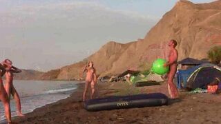 A group of naked people are playing badminton together