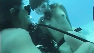 A man has sex with a girl under water in the pool