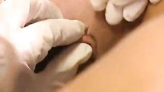 Girl plays with her clit piercing using a toy