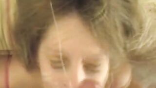A cumshot on the face of a blonde after giving a blowjob