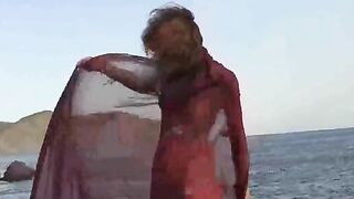 Nudist girl has small boobs and gets them wet in the ocean