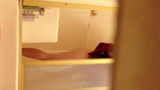A girl has a shower and is being filmed