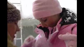 Two lesbians are having fun on a cold and snowy day