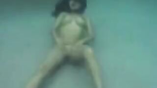 Sex in the ocean with a busty brunette and fake tits
