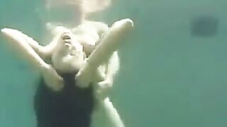 Sex in the ocean with a busty brunette and fake tits