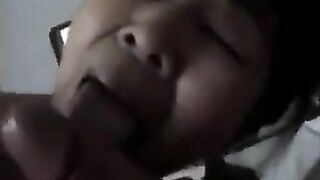 An elderly Chinese woman practices her blowjob skills