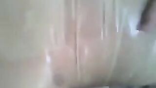 A guy put a condom on his dick and jerked it by hand