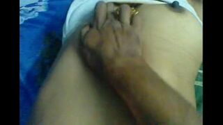 A husband massages the nipples of his wife in a steamy eporn scene