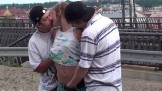 An amateur brunette has a hot threesome sex with two guys, showcasing her natural charm