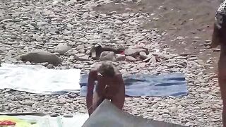 A couple of free-spirited lovers on a nudist beach, enjoying each other