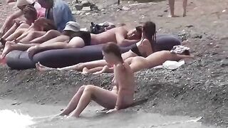 A couple of free-spirited lovers on a nudist beach, enjoying each other