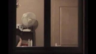 The guy admires himself in the mirror, standing completely naked in front of him
