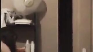 The guy admires himself in the mirror, standing completely naked in front of him