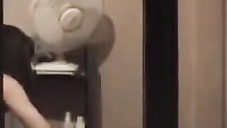 The guy admires himself in the mirror, standing completely naked in front of him