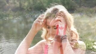Blonde tenderly caresses herself on the lake’s shore