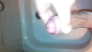 The kid caresses his dick in the shower and comes