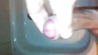 The kid caresses his dick in the shower and comes