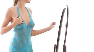 A girl is doing erotic moves in front of the mirror