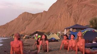A group of people play volleyball naked on the beach in this hot video
