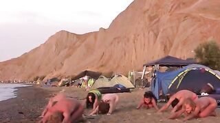 A group of people play volleyball naked on the beach in this hot video