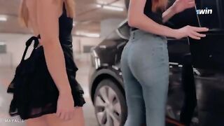 Two cute 18 y.o. girls are trying to hold their hood up