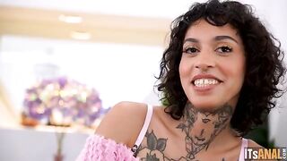 A girl is having sex with two guys at the same time on the couch
