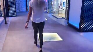 A saleswoman is ready to do anything to make a sale in the mall