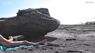 A spitting hot girl stripping on the nude beach and masturbating