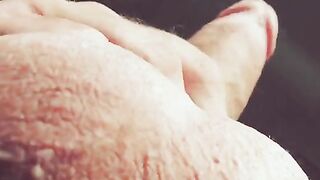 A guy masturbates his cock with his hand, moaning loudly and talking dirty