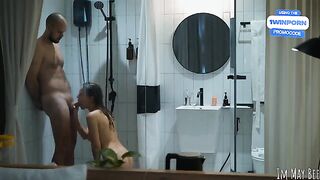 A couple gets intimate in the shower stall, exploring every moment