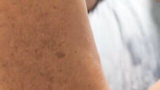 A woman caresses herself, using her fingers to bring herself to orgasm