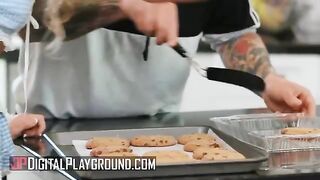 Petite Khloe Kapri bakes cookies in a revealing apron, showcasing her trimmed charm